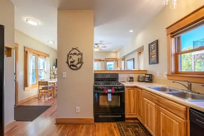 a kitchen with a sink and a stove at Riverbend views ten feet away in Granby