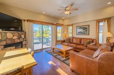 a living room with a couch and a fireplace at Riverbend views ten feet away in Granby