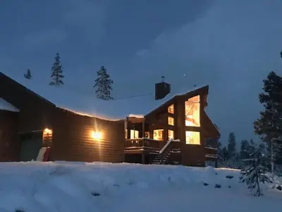 a log cabin in the snow at night at Take a break from it all escape to the mountains in Grand Lake