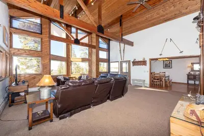 a living room with leather furniture and wooden ceilings at Take a break from it all escape to the mountains in Grand Lake