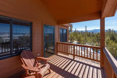 a rocking chair on the porch of a cabin at Take a break from it all escape to the mountains in Grand Lake
