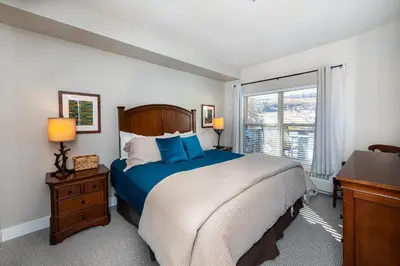 a bedroom with a large bed and a window at Base Camp Ski Slope Views Granby Ranch in Granby