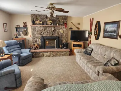 a living room with a couch and a fireplace at Rocky Mountain National Park Entrance one Mile in Grand Lake