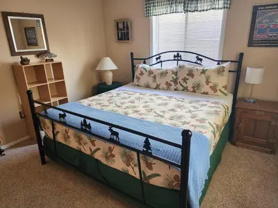 a bedroom with a bed with a bedspread with trees on it at Rocky Mountain National Park Entrance one Mile in Grand Lake
