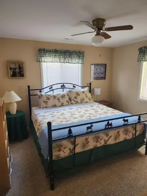 a bedroom with a bed and a ceiling fan at Rocky Mountain National Park Entrance one Mile in Grand Lake