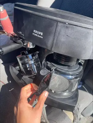 a person is working on a sewing machine at Riverfront Retreat Just 7 Minutes from the Resort, with a Hot Tub and Pool walk to downtown in Winter Park
