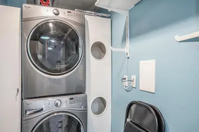 a washer and dryer sitting in a room at The Funky Flamingo - HOT TUB - BBQ - Fire Pit in Arvada