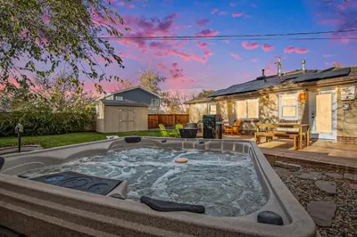 a hot tub in the backyard of a house at The Funky Flamingo - HOT TUB - BBQ - Fire Pit in Arvada