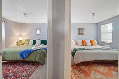 a bedroom with two beds and a window at Vibrant and spacious 3 level home by park in Northglenn