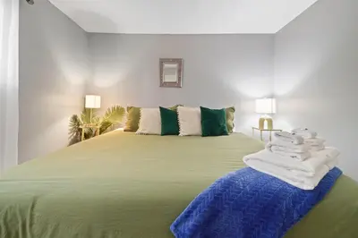 a bedroom with a large bed with towels on it at Vibrant and spacious 3 level home by park in Northglenn