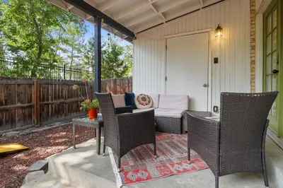 a patio with wicker chairs and a table at Vibrant and spacious 3 level home by park in Northglenn