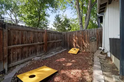 a backyard with a wooden fence and a wooden box at Vibrant and spacious 3 level home by park in Northglenn