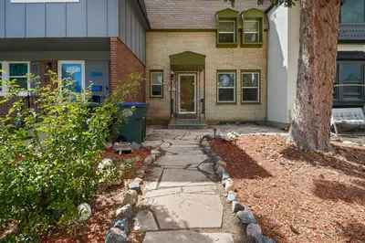 a house with a tree and a walkway at Vibrant and spacious 3 level home by park in Northglenn