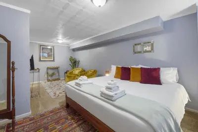 a bedroom with a large bed with towels on it at Vibrant and spacious 3 level home by park in Northglenn