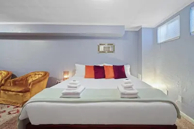 a bedroom with a large bed with towels on it at Vibrant and spacious 3 level home by park in Northglenn
