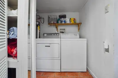 a small kitchen with a stove and a refrigerator at Whimsical Berkeley Bungalow in Denver