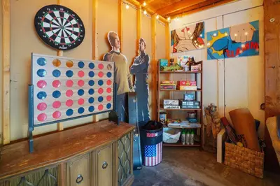 a room with a dart board and a mannequin and a target at Whimsical Berkeley Bungalow in Denver