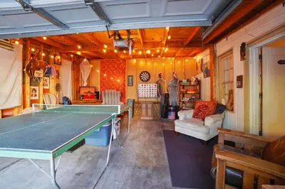 a living room with a ping pong table in it at Whimsical Berkeley Bungalow in Denver