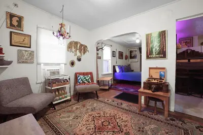a living room with a couch and a chair at Whimsical Berkeley Bungalow in Denver