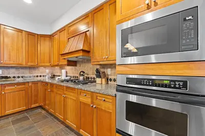 a kitchen with wooden cabinets and stainless steel appliances at Lone Eagle 3012 in Keystone