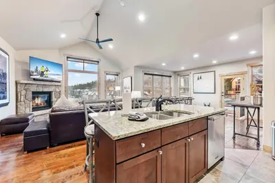 a kitchen and living room with a fireplace at Modern Keystone Townhome Next to River Run Village in Keystone