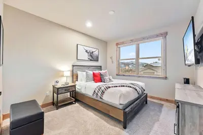 a bedroom with a bed and a window at Modern Keystone Townhome Next to River Run Village in Keystone