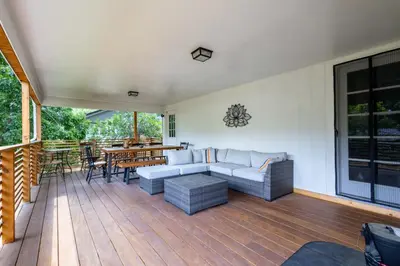 a patio with a couch and a table on a deck at Foothills Escape - 10 min to Red Rocks in Lakewood