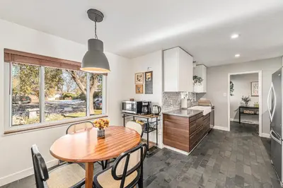 a kitchen and dining room with a table and chairs at Foothills Escape - 10 min to Red Rocks in Lakewood