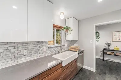 a white kitchen with a sink and a window at Foothills Escape - 10 min to Red Rocks in Lakewood