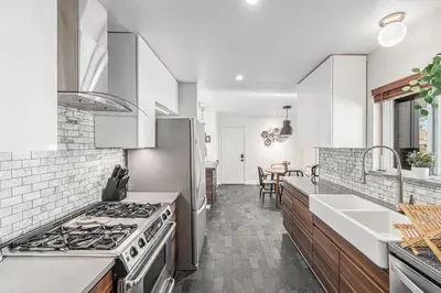 a kitchen with a stove and a sink at Foothills Escape - 10 min to Red Rocks in Lakewood