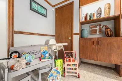 a room with a couch and toys and a shelf at Foothills Escape - 10 min to Red Rocks in Lakewood