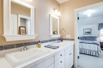 a bathroom with two sinks and a mirror at Walk to DU, Dining and Parks Spacious Denver Home! in Denver