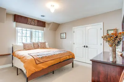 a bedroom with a bed and a table and a window at Walk to DU, Dining and Parks Spacious Denver Home! in Denver