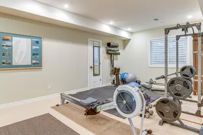 a home gym with a treadmill and a fan at Walk to DU, Dining and Parks Spacious Denver Home! in Denver