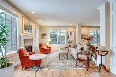 a living room with a couch and chairs and a fireplace at Walk to DU, Dining and Parks Spacious Denver Home! in Denver