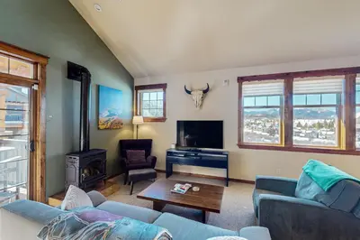 a living room with a couch and a tv at Byers Peak Mountain Escape – Winter Park Retreat with Scenic Views in Fraser