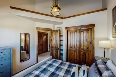 a bedroom with a bed and a dresser and a mirror at Byers Peak Mountain Escape – Winter Park Retreat with Scenic Views in Fraser