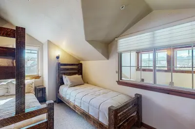 a bedroom with two bunk beds and a window at Byers Peak Mountain Escape – Winter Park Retreat with Scenic Views in Fraser