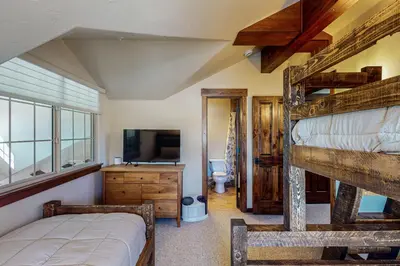 a bedroom with a bunk bed and a television at Byers Peak Mountain Escape – Winter Park Retreat with Scenic Views in Fraser