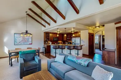 a living room with a couch and a table and a kitchen at Byers Peak Mountain Escape – Winter Park Retreat with Scenic Views in Fraser