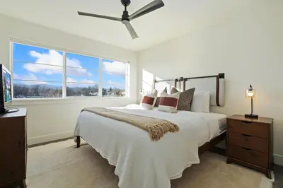 a bedroom with a large bed and a large window at Mountain View Home with King Beds and Rooftop Deck in Fort Collins