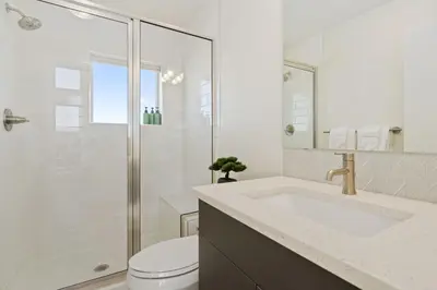 a bathroom with a toilet and a sink and a shower at Mountain View Home with King Beds and Rooftop Deck in Fort Collins