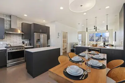 a kitchen with a table and chairs in a kitchen at Mountain View Home with King Beds and Rooftop Deck in Fort Collins