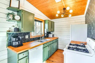 a kitchen with green cabinets and a stove at Mtn-View Haven with Hot Tub 9 Mi to Dtwn Bailey in Bailey