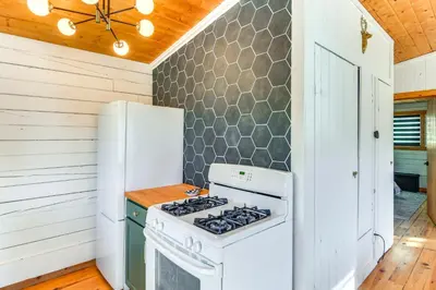 a kitchen with a stove and a refrigerator at Mtn-View Haven with Hot Tub 9 Mi to Dtwn Bailey in Bailey
