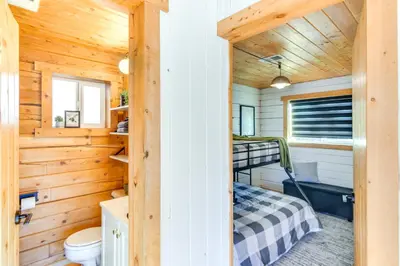 a bedroom in a log cabin with a bunk bed at Mtn-View Haven with Hot Tub 9 Mi to Dtwn Bailey in Bailey