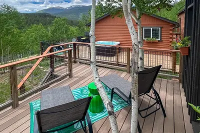 a deck with a table and chairs and a grill at Mtn-View Haven with Hot Tub 9 Mi to Dtwn Bailey in Bailey