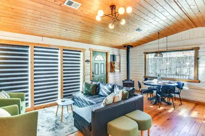 a living room with a couch and a table at Mtn-View Haven with Hot Tub 9 Mi to Dtwn Bailey in Bailey