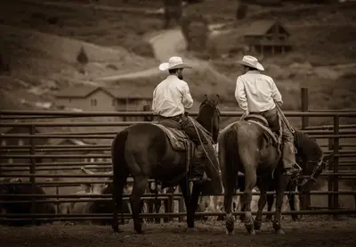 two men riding on horses in front of a fence at Aspen Meadows F-304, 0014 in Granby