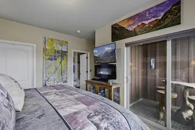 a bedroom with a bed and a flat screen tv at Aspen Meadows F-304, 0014 in Granby